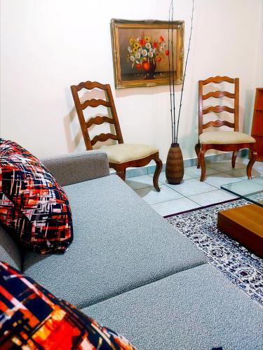 a living room with a couch and two chairs at Casa Rosa in Nanyuki