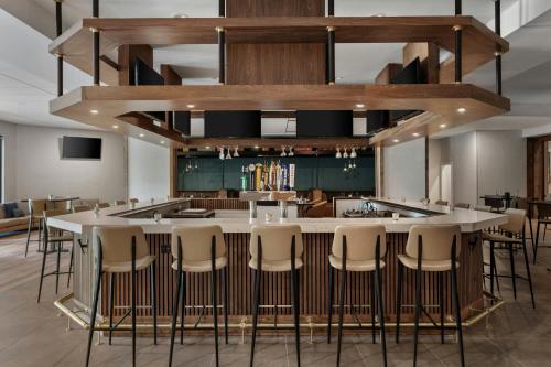 a bar in a restaurant with stools at Delta Hotels by Marriott Bristol in Bristol