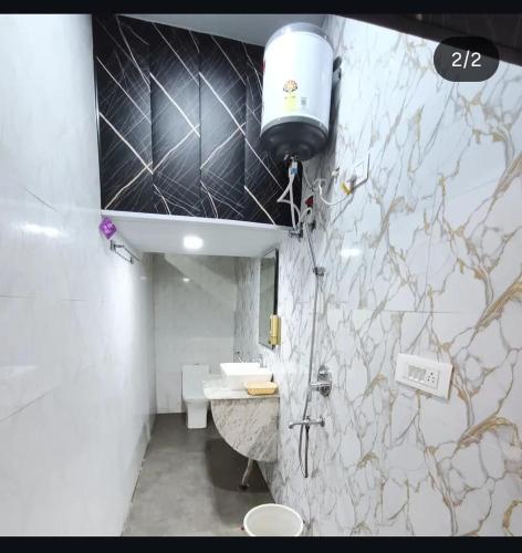 a bathroom with a sink and a shower in it at Heavens Hotel in Agra