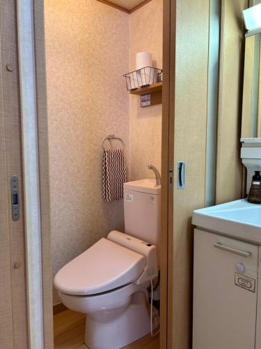a small bathroom with a toilet and a sink at Nagi Takamatsu 702 in Takamatsu