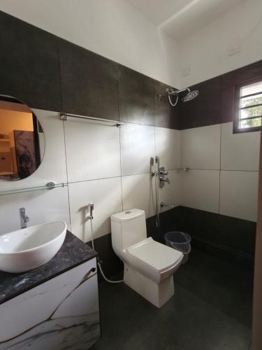 a bathroom with a white toilet and a sink at Misty cloud homestay in Pīrmed