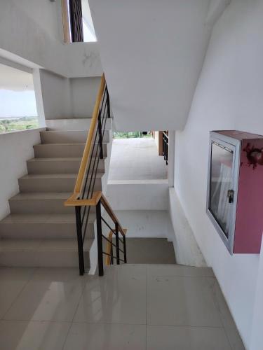 a staircase in a house with white walls at Central City Condo Getaway in Gun-ob