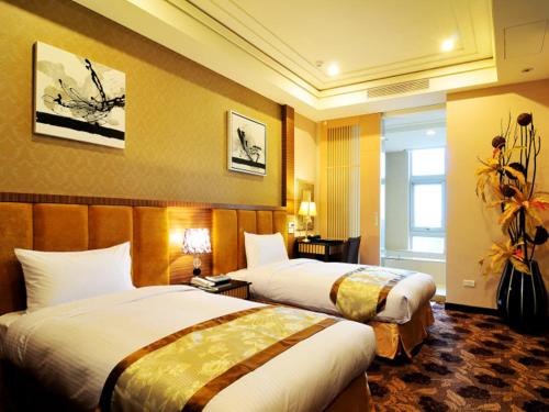 a hotel room with two beds and a window at JinShan Sakura Bay Hot Spring Hotel in Jinshan