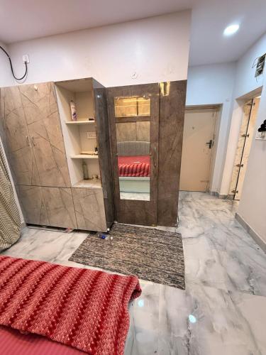 a room with a door with a red rug on the floor at Chill Vibes in Visakhapatnam