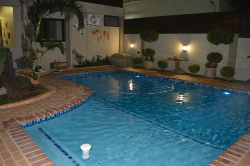 a large swimming pool in a hotel room at GuestHouse 1109 in Maputo