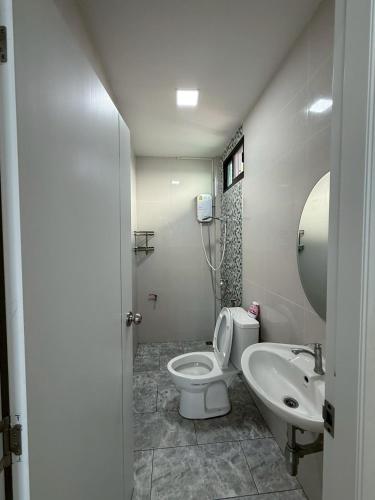 a bathroom with a toilet and a sink at พิงภู ไทรโยค กาญจนบุรี in Sai Yok