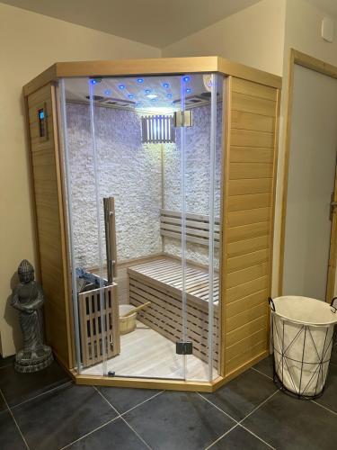 a shower with a glass enclosure in a room at Nuit Détente Rodez in Rodez
