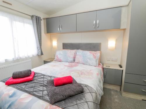 a bedroom with a bed with two pillows on it at Happy Daze in Bridlington