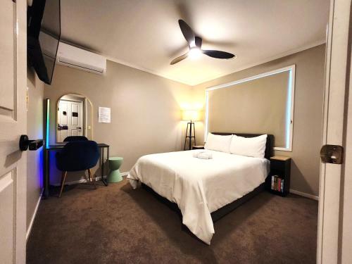 a bedroom with a bed and a ceiling fan at Private Room 3- The Smart Stay in Craigieburn