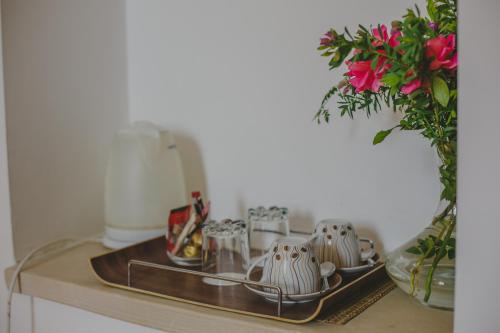 a tray with cups and dishes on a counter at Alkisti City Hotel in Larnaka