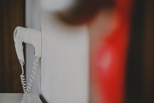 a white phone is hanging on a wall at Alkisti City Hotel in Larnaka