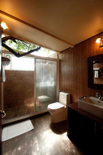 a bathroom with a toilet and a shower and a sink at The Tree House Resort, Jaipur- A Club Mahindra Associate in Jaipur