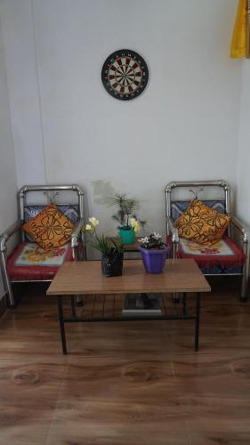 a room with two benches and a table with two chairs at Tranquil Retreat Homestay in Ghum