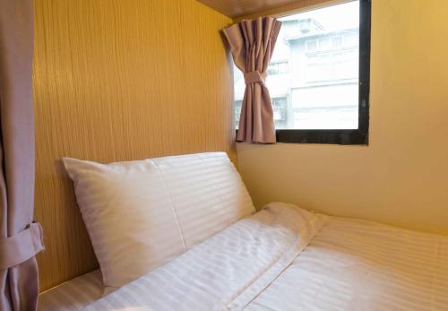 Postel nebo postele na pokoji v ubytování Fun Inn Taipei Hostel