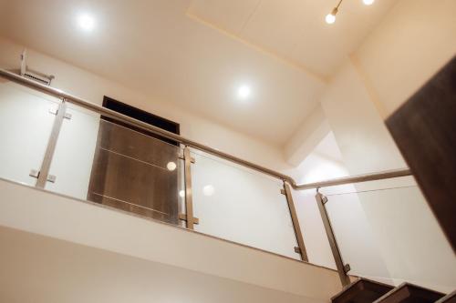 a staircase in a building with a glass railing at Capetown Shaadows in Igatpuri