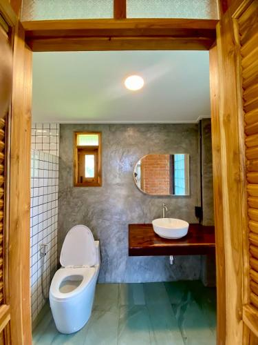 a bathroom with a toilet and a sink at Latehouse bar Amphawa in Amphawa