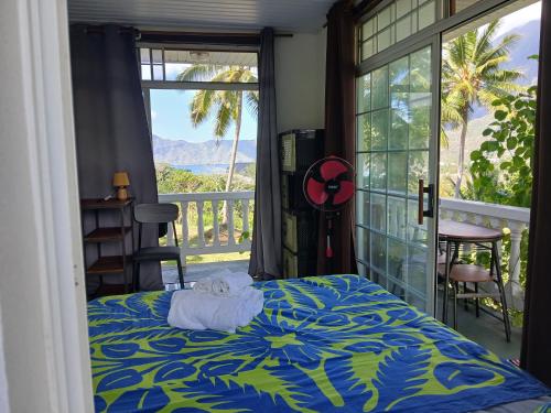 a bedroom with a bed with a towel on it at Hiva Oa Villa Lodge in Hiva Oa