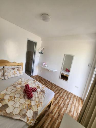 a bedroom with a bed with a red bow on it at Little Zabina Inn in San Juan