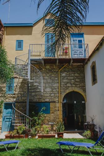a building with a staircase and a balcony at Alkisti City Hotel in Larnaka