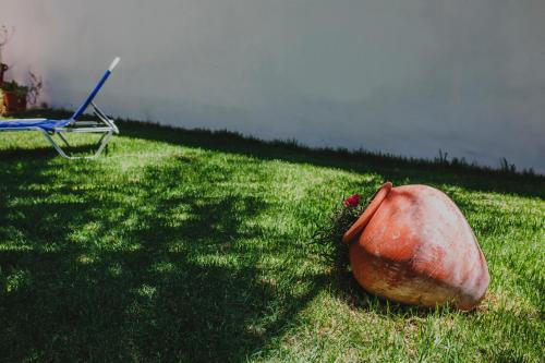 a boat sitting on the grass next to a chair at Alkisti City Hotel in Larnaka