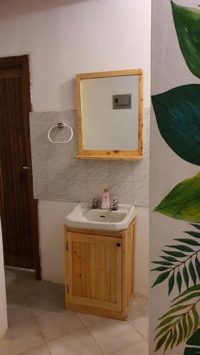 a bathroom with a sink and a mirror at Kabila moja hostel in Iringa