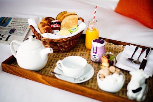 a tray of breakfast foods and a basket of bread at Hotel Du Vin & Bistro Brighton in Brighton & Hove