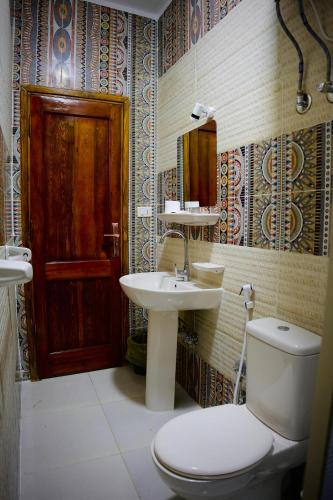 a bathroom with a toilet and a sink and a mirror at Nuba Nest in Aswan