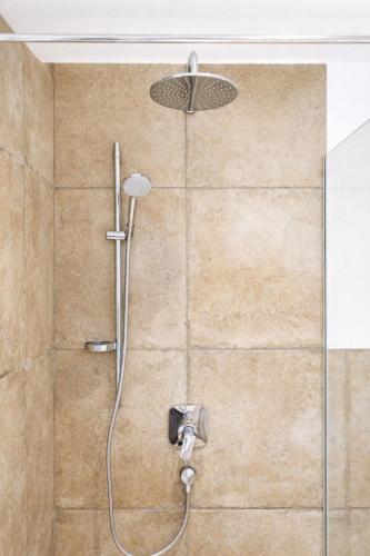 a shower with a shower head in a bathroom at Kramerl in Bruck an der Großglocknerstraße
