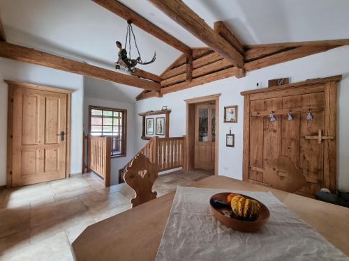 a living room with a table and wooden ceilings at Kramerl in Bruck an der Großglocknerstraße