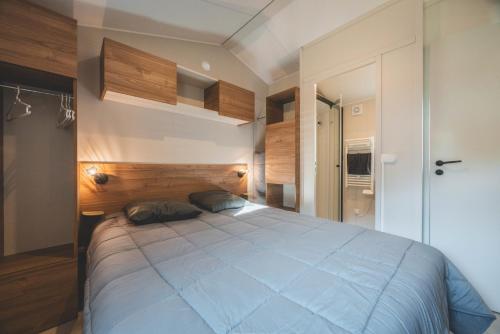 a bedroom with a large blue bed in it at Camping Le Malazéou Wellness Sport Camping in Ax-les-Thermes