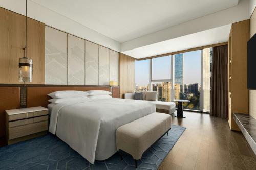 a bedroom with a large white bed and a large window at Xi'an Marriott Hotel High-Tech Zone in Xi'an