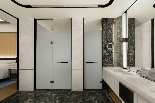a bathroom with a sink and a bed at Xi'an Marriott Hotel High-Tech Zone in Xi'an