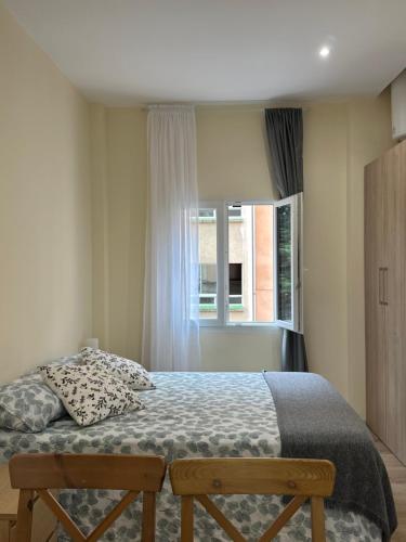 a bedroom with a bed and a window at ARBE Apartamentos in Bilbao
