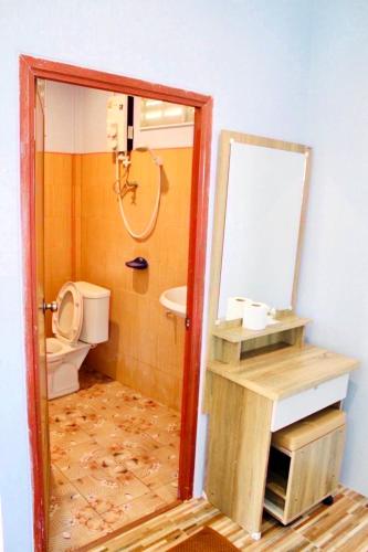 a bathroom with a toilet and a mirror at Sai Klong Song Lae Resort Pakpra Phatthalung in Phatthalung