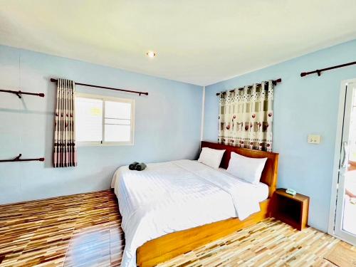 a bedroom with a large bed and a window at Sai Klong Song Lae Resort Pakpra Phatthalung in Phatthalung