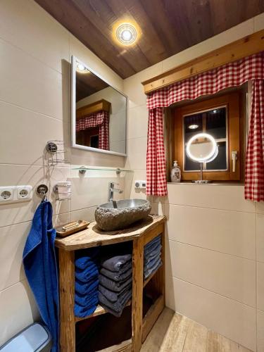 a bathroom with a sink and a mirror at Die Petzl Hütte - Kreischbergblick in Kaindorf