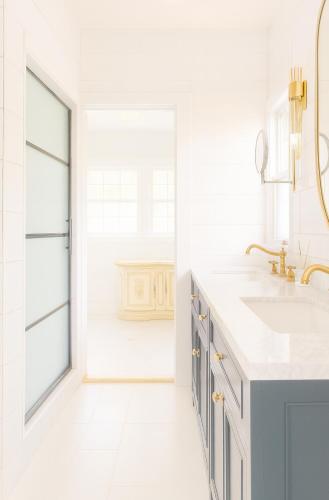 a white bathroom with a sink and a window at Luxurious Hollywood Homestay in Los Angeles