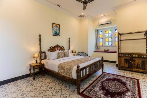 a bedroom with a large bed and a window at Aryavarta A Boutique Resort in Nāi