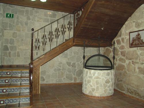 a staircase in a room with a stone wall at La Hacienda de mi Señor in Lerma