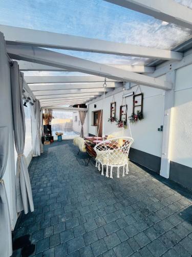 a room with a patio with a white ceiling at Apartamenty u Petuski z Jacuzzi in Szaflary