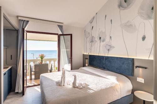 a bedroom with a bed with a view of the ocean at Del Prado in Riva Ligure