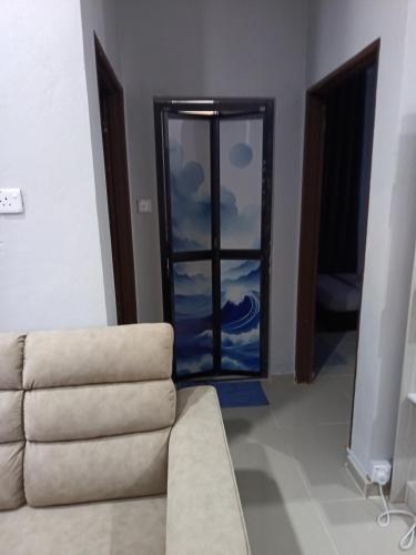 a living room with a couch and a window at D'Yaya Homestay in Kampong Pengkalan Nyireh