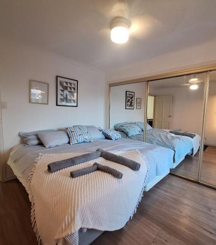 a bedroom with two beds with towels on them at Exclusive Sunrise Room, GC Blues Festival, Cool Autumn, Fire Pits, Fishing in Gold Coast