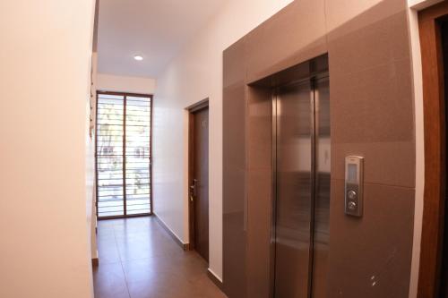 a hallway with a stainless steel refrigerator at Pearl Suites in Cochin