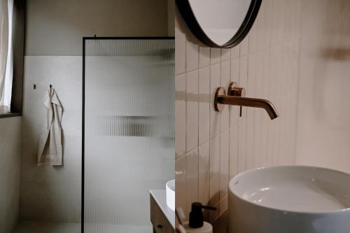 a bathroom with a sink and a mirror at BAUA Gartenhaus in Maurach