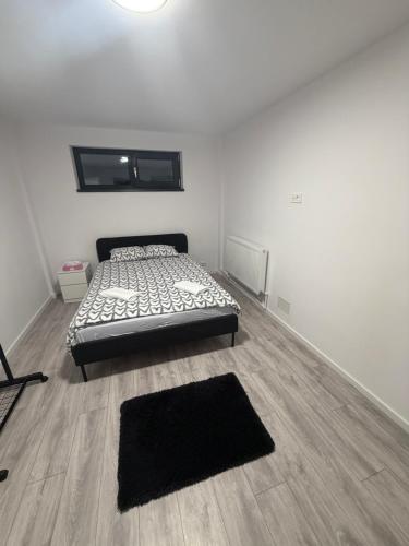 a bedroom with a bed and a wooden floor at EVEREST 33 Garsoniera in Bucharest