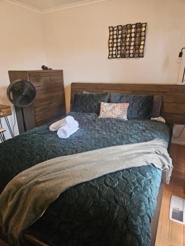 a bedroom with a large bed with two towels on it at Cozy Escape in Sunbury