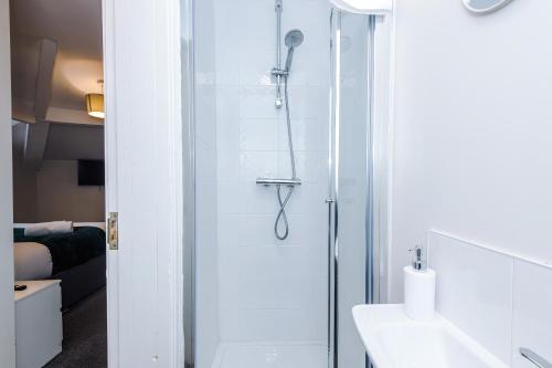 a shower with a glass door in a bathroom at Spacious 6-Bedroom Central Blackpool in Blackpool