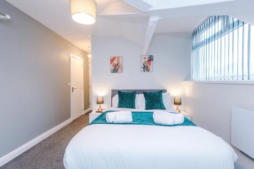 a bedroom with a large white bed and a window at Spacious 6-Bedroom Central Blackpool in Blackpool