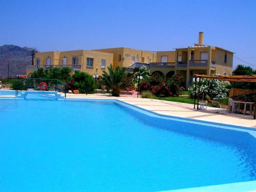 a large blue swimming pool in front of a building at Anthemis in Stavros